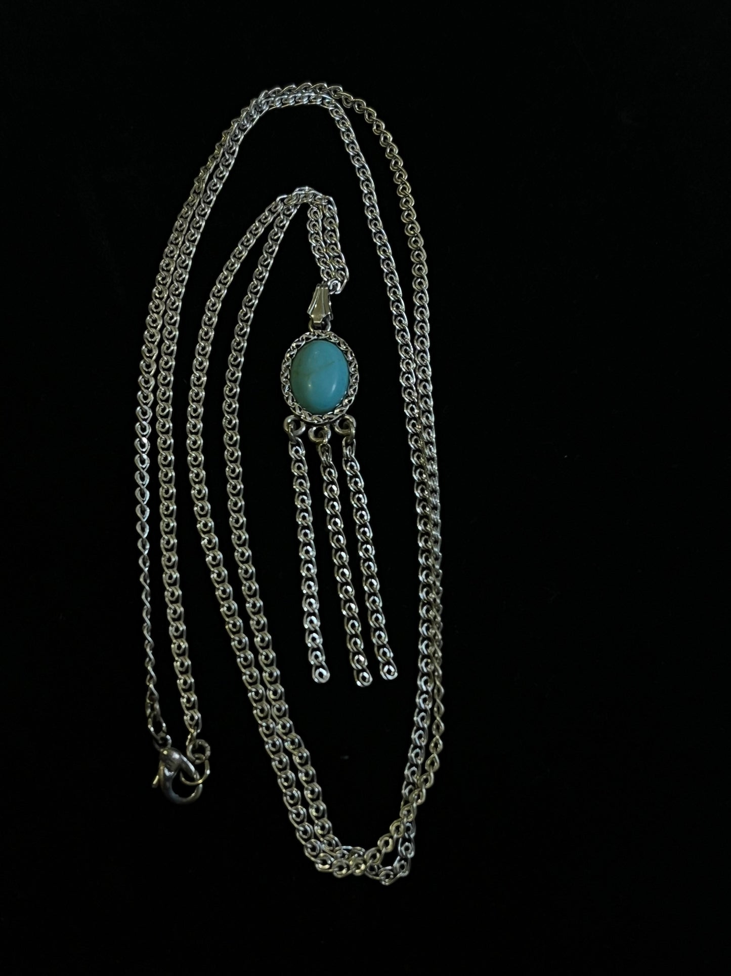 An antique silver pendant with turquoise and marcasite